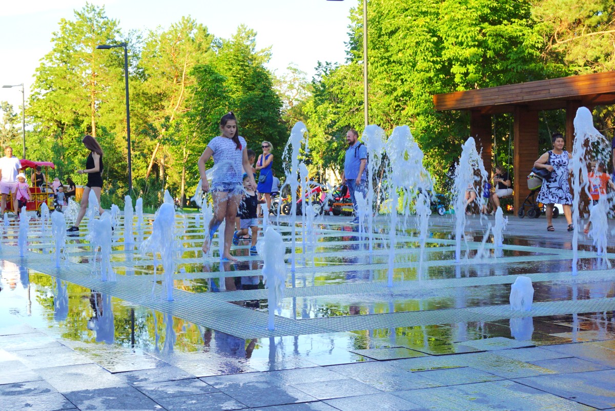 Kids playing in the waterpark by the river.